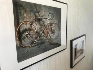a painting of a bike hanging on a wall at Pension Central - Ihre Fahrradfreundliche Unterkunft in der Altstadt in Lutherstadt Wittenberg