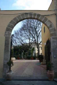 an archway in the side of a building at Hotel d'Orleans in Palermo
