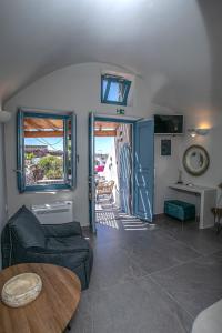 a living room with a couch and a table at Arck Suites in Foinikiá