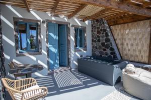 a patio with a bench and a table and chairs at Arck Suites in Foinikiá