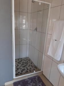 a bathroom with a shower and a sink at Fumas guesthouse in Duvhapark +18 photos