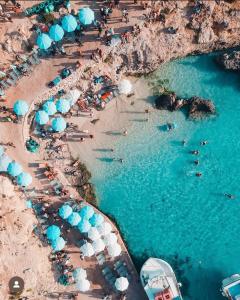 an aerial view of a beach with people and umbrellas at Fancy Modern APT Sliema - w/ 2BR in Sliema