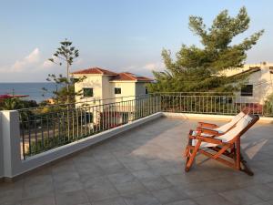 a pair of chairs sitting on a balcony with the ocean at Aegina Vagia Sea Breeze Vacation Villa in Vaia