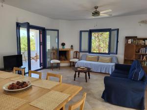 a living room with a couch and a table at Aegina Vagia Sea Breeze Vacation Villa in Vaia