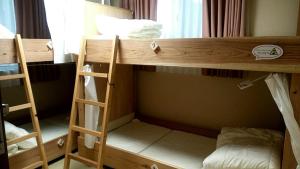 a group of bunk beds in a room at Fukuoka Guest House Jikka in Fukuoka