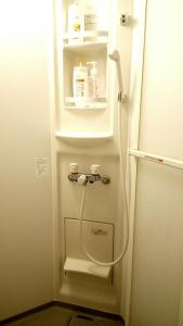 a refrigerator with its door open with a hose inside at Fukuoka Guest House Jikka in Fukuoka