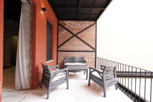 two chairs and a table on a balcony at Monev Suites Hotel in Istanbul
