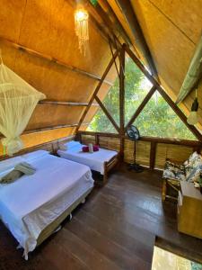 a bedroom of a yurt with a bed and a window at Sitio Simple Life in Ubatuba +153 photos