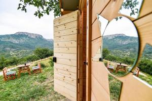 a room with a view of mountains through a door at Cozy barrel in Nikšić