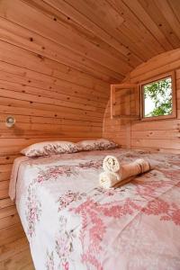 a bedroom with a bed in a wooden cabin at Cozy barrel in Nikšić