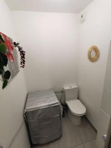 - une petite salle de bains avec toilettes et tabouret dans l'établissement Magnifique appartement pour 8 personnes à Montpellier - WIFI/PARKING, à Montpellier
