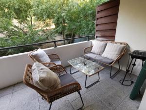 d'un balcon avec deux chaises et une table. dans l'établissement Magnifique appartement pour 8 personnes à Montpellier - WIFI/PARKING, à Montpellier