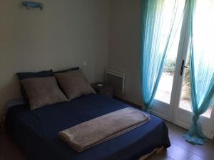 a bedroom with a bed with blue sheets and a window at Villa neuve piscine chauffée - St Vallier de Thiey in Saint-Vallier-de-Thiey +19 photos