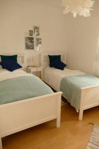 a bedroom with two beds with blue pillows at Ferienwohnung Wengerner Mühle in Wetter