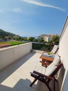 a balcony with a table and chairs on a roof at Apartments Mak & Lux in Dubrovnik
