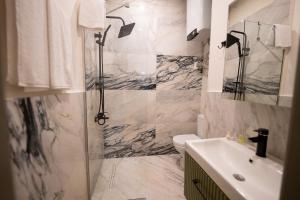 a bathroom with a shower and a toilet and a sink at Monev Suites Hotel in Istanbul +58 photos