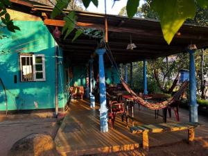 a porch with a hammock and a house at The 1964 Holiday bungalow in Ella