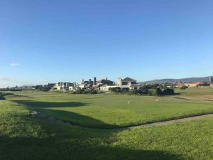 a view of a golf course with houses in the background at Golf Estate apartment close to the Beach in Cape Town