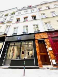 a store on a street in front of a building at Dream Dwell Paris-Chic flat in the heart of Marais near Pompidou Centre in Paris