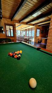 a pool table with balls on top of it at Leśna Osada Szegdy 