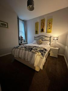 a bedroom with a large bed and a window at Cozy apartment 1 in Worcester