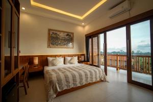 a bedroom with a bed and a balcony at Wakasuta House in Ubud +103 photos