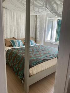 a bed with a canopy in a bedroom at Townhouse Rustik Portoroz in Portorož