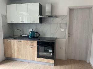 a kitchen with a sink and a stove at Townhouse Rustik Portoroz in Portorož +54 photos