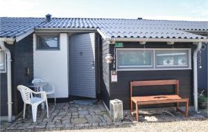 a small shed with a table and a bench at Beautiful Apartment In Vejers Strand With 1 Bedrooms And Wifi in Vejers Strand
