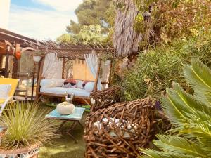 a patio with chairs and a hammock and plants at chez Guy in Marseille