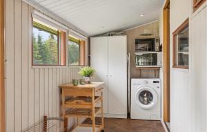 a tiny house with a washer and dryer in a room at Beautiful Home In Vggerlse With Kitchen in Bøtø By