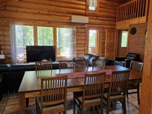 a dining room with a wooden table and chairs at Vacation Home Kuhmanne in Vehvilä