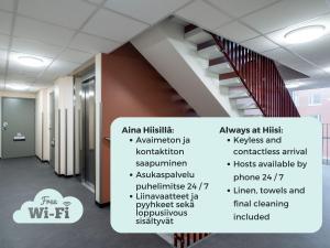 a staircase in a office building with a list of stairs at Hiisi Homes Espoo Finnoo in Espoo