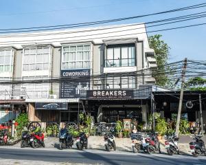 a group of motorcycles parked in front of a building at Breakers Hotel Rawai in Phuket