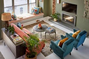 a living room with a couch and chairs and a fireplace at Pineapple House Boutique Hotel in Cape Town