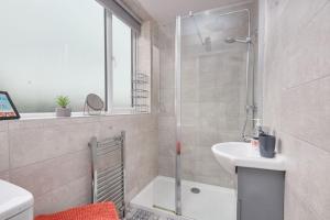a bathroom with a shower and a sink at Haw Hill House - modern 4 bed in Normanton