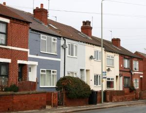 a row of houses on the side of a street at Haw Hill House - modern 4 bed in Normanton