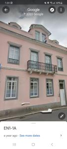 a picture of a pink house with a balcony at Penthouse Furnas in Furnas