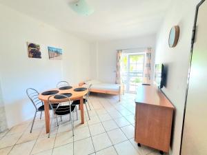 a kitchen and dining room with a table and chairs at Apartments Mostak in Baška