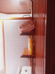 a bathroom with a shelf with towels on it at Chalet's lake_Bolu Abant _log house in Piroğlu