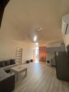 a living room with a couch and a table at SUNSHINE Hotel Kvariati in Kvariati