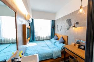 Katil atau katil-katil dalam bilik di Gongxili - Chujian Hotel