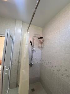 a bathroom with a shower with a shower curtain at SUNSHINE Hotel Kvariati in Kvariati