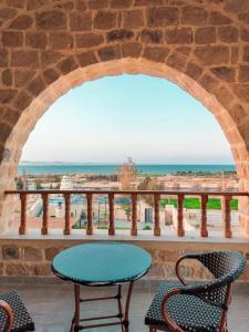 a patio with a table and chairs and the ocean at كمبوند قرية تونس in Tunis