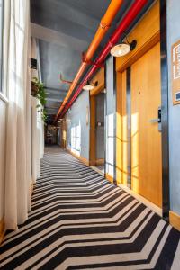 a hallway of an office building with a striped carpet at Gongxili - Chujian Hotel in Kunming