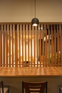 a dining room with a wooden table and chairs at Shizuoka Town Hotel in Shizuoka