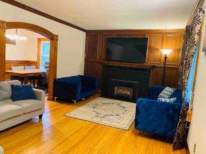 a living room with a couch and a fireplace at HIDDEN GEM near the Niagara falls in Welland