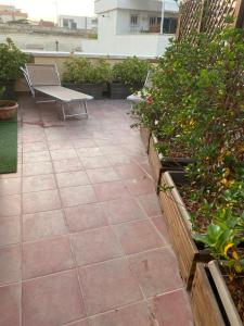 a patio with a bench and some plants at La piccola terrazza in Bari