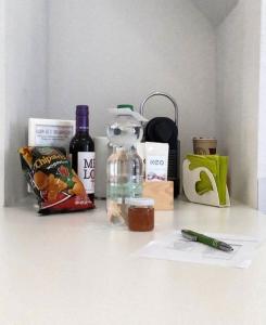a white counter with a bottle of wine and other items at Ruhige-Ferienwohnung-auf-Pferdehof in Dreetz