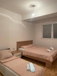 a bedroom with two beds and a ceiling at Apartments Stela Rosa Ohrid in Ohrid
